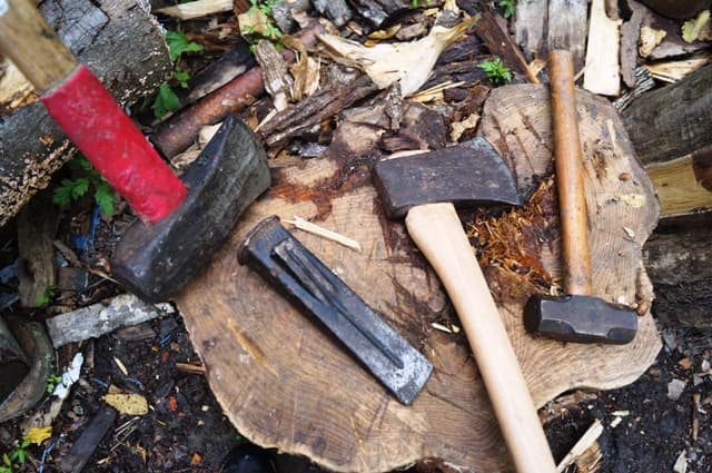 The four main tools I like to use in wood cutting: (from left to right) splitting maul, wedge, ax, and hammer.