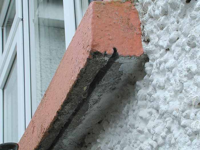 Slot on the underside of a windowsill (cill). This prevents water from running back against the wall and should be clear of cement or other debris