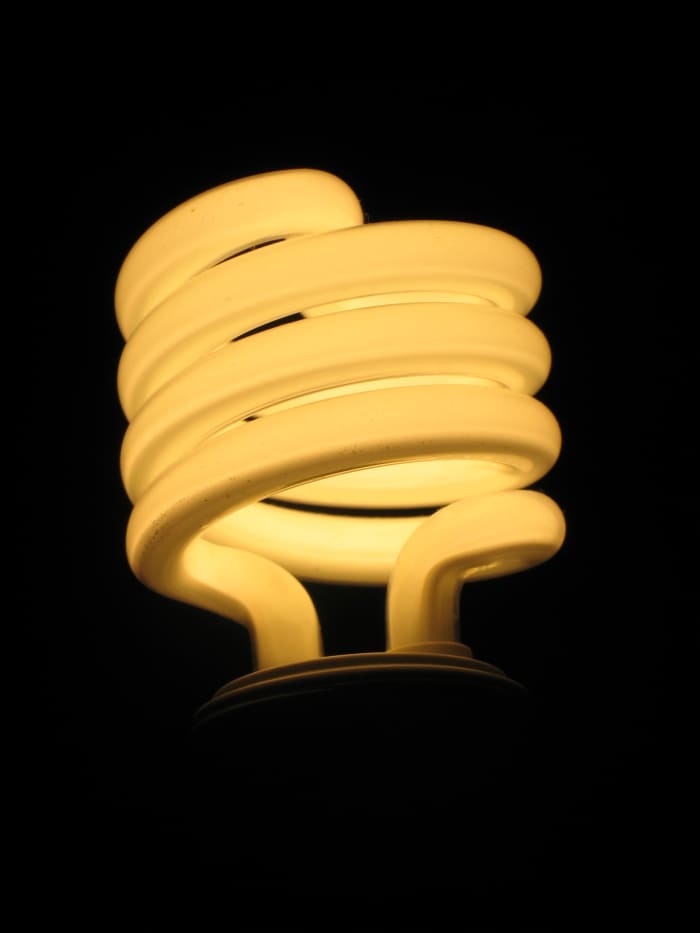 A modern CFL, compact fluorescent lamp, lit up.