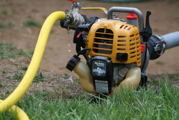 We use a water transfer pump, fitted with strong, larger hoses, to move water from our biggest storage tank to the smaller ones during long periods of no rain.