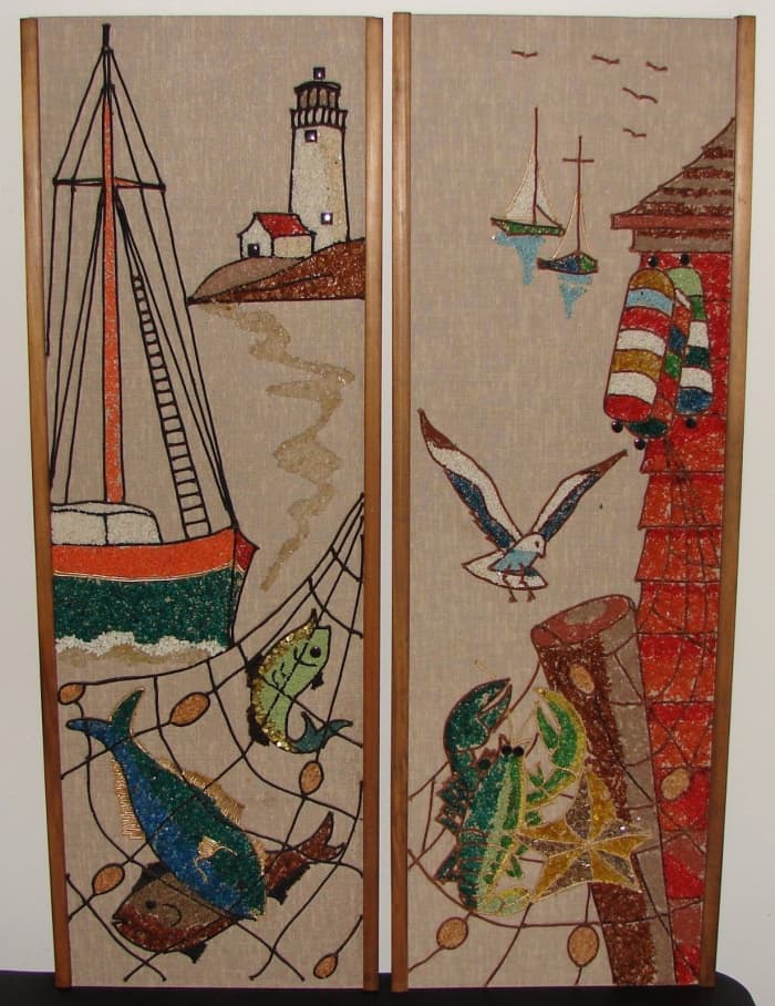 Two lovely gravel wall pieces adorned with a seascape, coastline, ocean life, lighthouse, and boats. Each measures 36 inches tall x 12 inches wide and has wood trim.