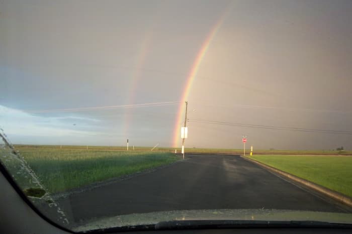 A late spring storm passes over cropland.leaving a double rainbow in its wake near Othello, Washington