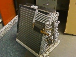 This is what an evaporator coil looks like. You can see here how tightly together the fins on your evaporator coil are. It doesn't take a whole lot of debris to restrict the air that should be moving through them or clog that drain pan under it.