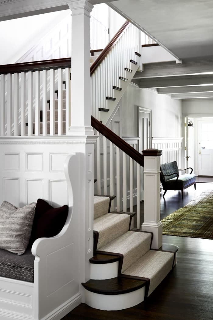This renovation has plenty of architectural detail: wainscoting, built-in seating, traditional newel posts, railings and balustrades.