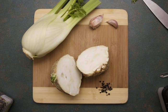 To peel the hypocotyl, slice it in half. Lay it cut side down and use a paring knife or peeler to remove the skin.