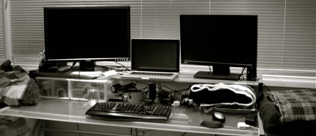 My setup when I was a technical writer: monitors at eye height, separate mouse and split keyboard to keep my chest open.