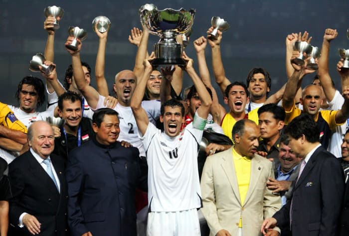 Iraq's Younis Mahmoud (10) hoists the trophy along with teammates and other dignitaries after Iraq won the 2007 Asian Cup in Jakarta, Indonesia