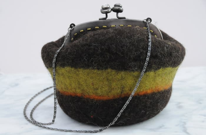 This is a wet felted shoulder purse and recycled purse frame made on a Gertie ball.