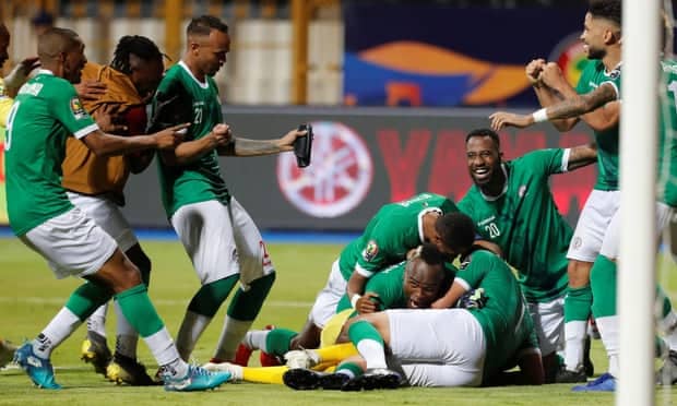 Madagascar's Thomas Fontaine (#21) and Romain Métanire (#20) celebrate following the conclusion of a 2019 Africa Cup of Nations Round of 16 match against DR Congo in Alexandria, Egypt. Madagascar reached the quarterfinals in its debut.