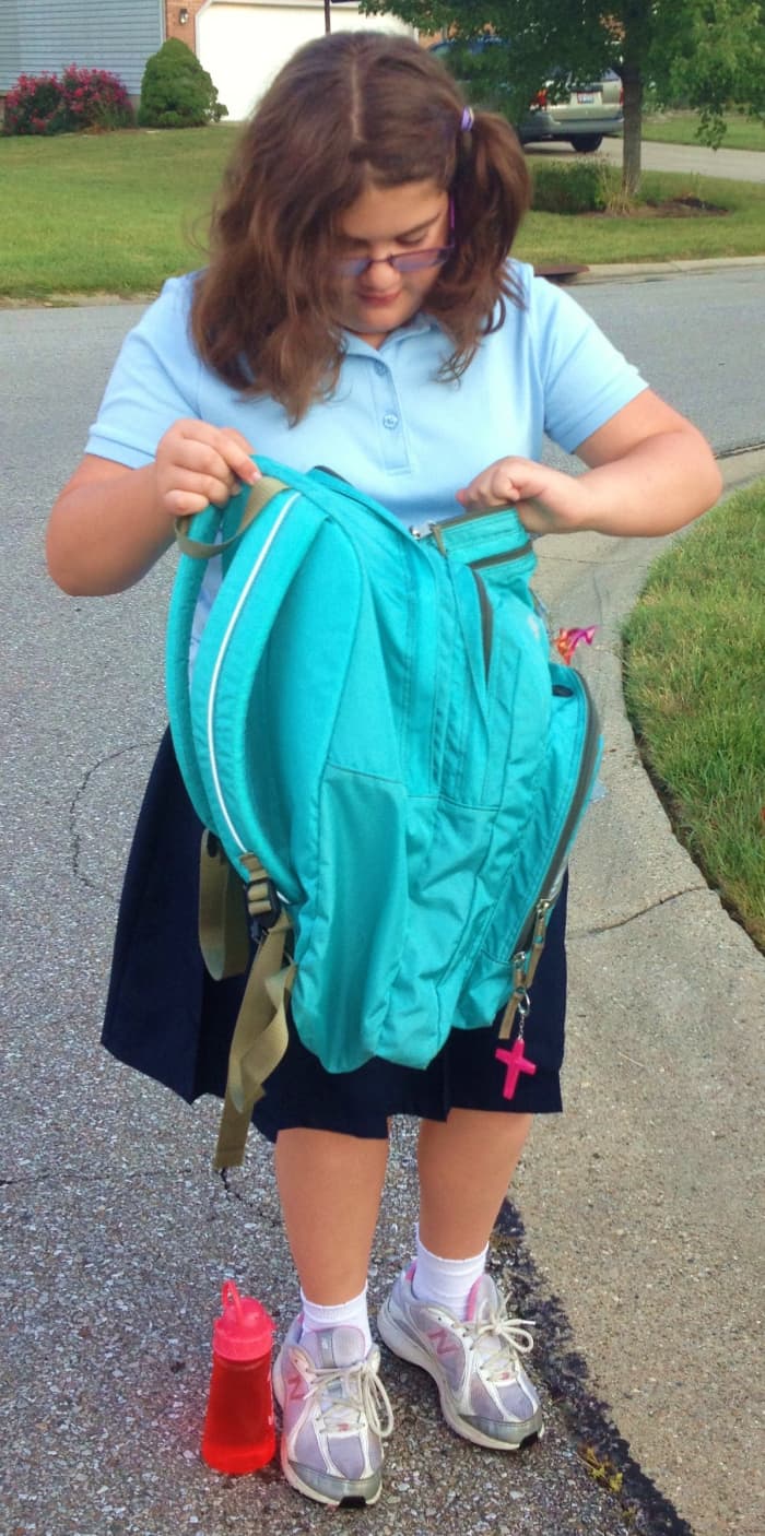 What's in my trusty backpack? Children pack their bags with school supplies and necessary personal items such as snacks, water, and clothing.