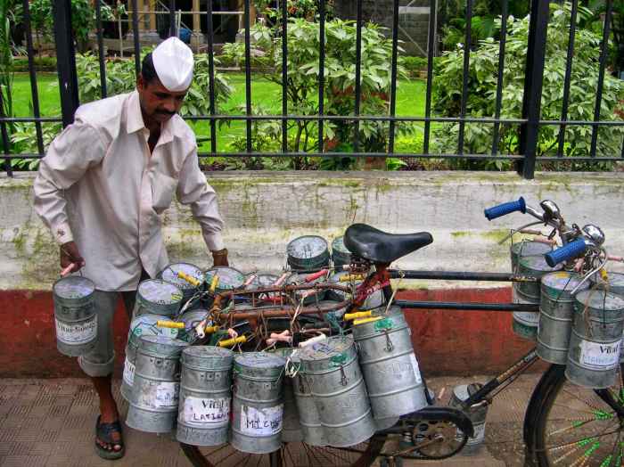 A dabba wallah loads his bicycle.