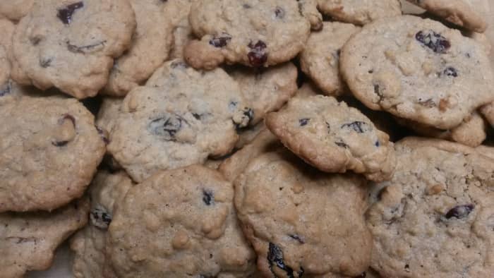 A batch of oatmeal raisin cookies made with cherries and cranberries.