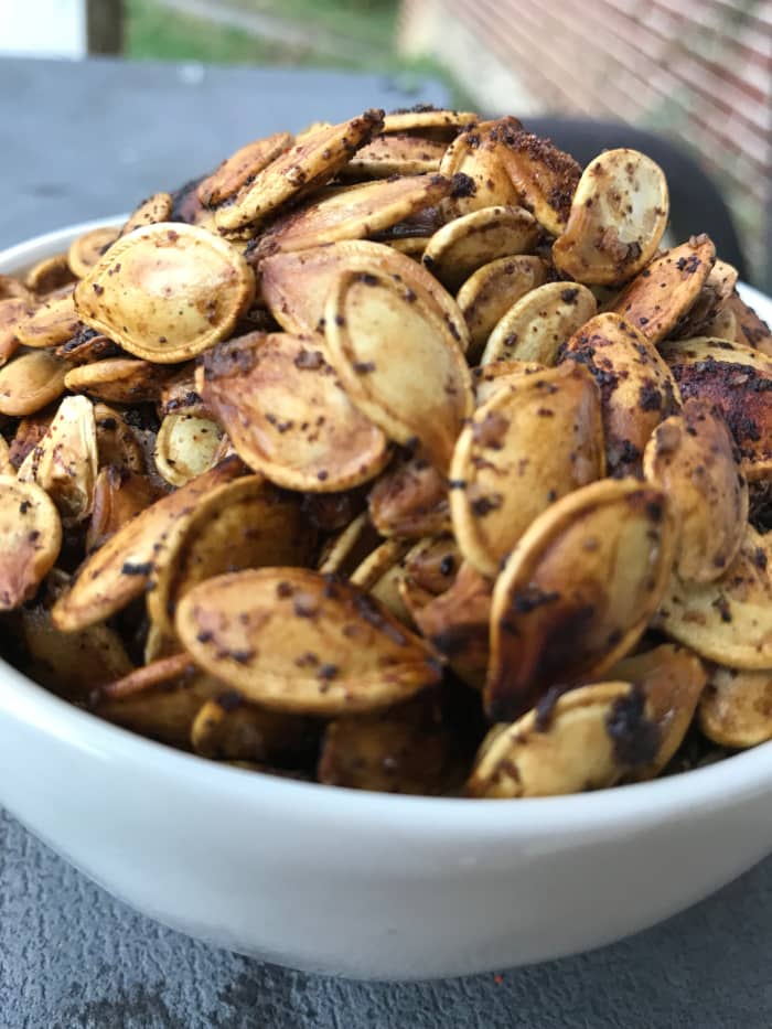 Roasted pumpkin seeds make a super simple, delicious and nutrition packed snack that you actually want your family to eat! Crunchy, salty and loaded with flavor, this is an ideal fall treat.