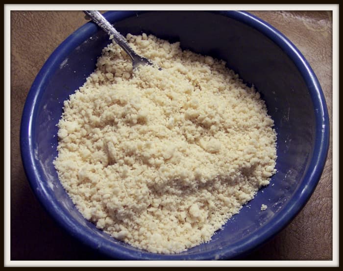 With a whisk or a fork, combine the flour and the salt in a bowl. Add the vegetable shortening. Cut the shortening into the flour with a pastry blender, a fork, or even your hands.