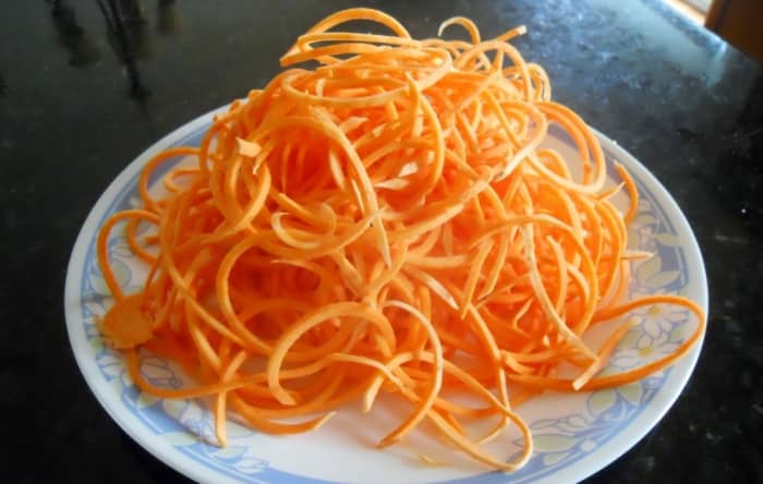 Swoodles - Sweet Potato Noodles - A peeled sweet potato is placed in the spiralizer. I find it easier to cut the potato in half so there is a flat side. The 1/8 inch (3 mm) blade was used.
