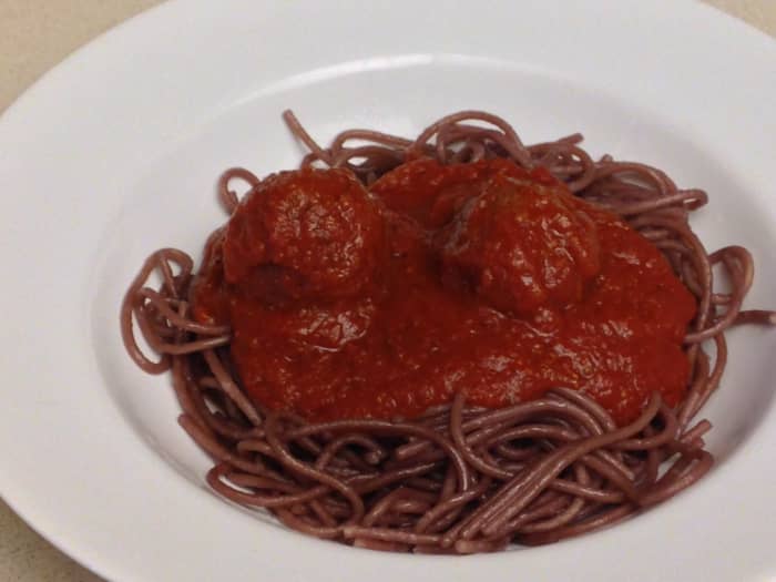 Drunken spaghetti noodles, boiled in red wine. Served with tomato sauce and meatballs.