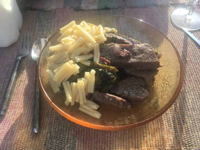 Braised roast with bacon, prosciutto, and asparagus in a red wine sauce