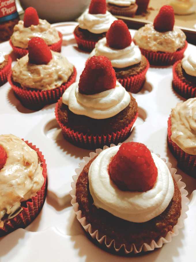 German chocolate cupcakes with vanilla frosting or coconut pecan frosting and raspberry garnish