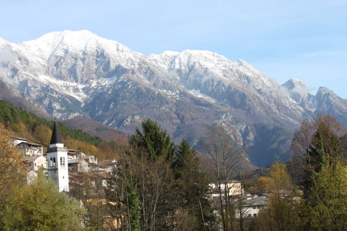 View of Stolvizza, Italy. Stolvizza offers beautiful natural paths in the Italian Alps, great for hiking and mountain biking. The views are stunning and the paths are full of historic sites including WWII trenches and old limestone artifacts.