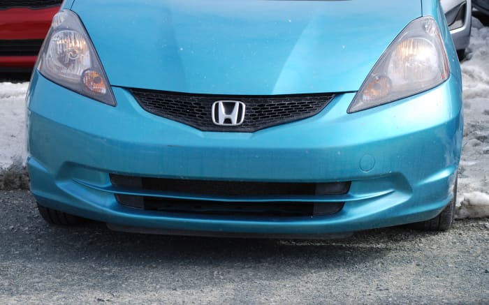 A great number of vehicles appear to be either smiling or scowling at me as a drive past them. This one happens to be smiling.