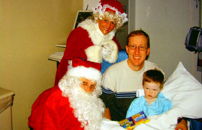 Santa Claus visits the pediatric intensive care unit during his recovery from supraglottoplasty.