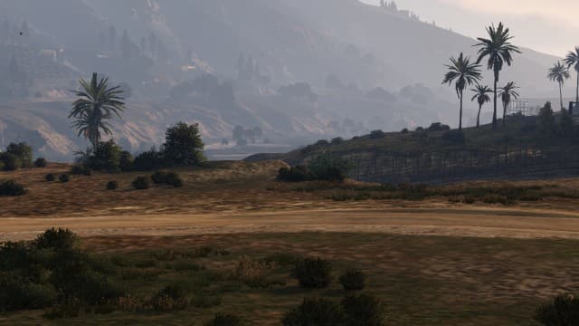 You can use this landmass to enter the base easily, aim for between these two bushes to clear the fence. The next-gen version has more foliage making the "land ramp" in the first screenshot harder to spot (as seen in the video walkthrough).