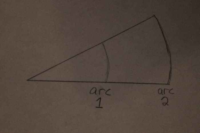 Both arcs have the same angle, but arc 2 has more length by which to reference changes in angle. Use arc 2.