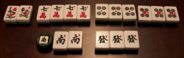 A winning hand in majhong - 1 khan, 3 pong melds, 1 pair and two special tiles. Even better, the wind (south) is the wind of the round!