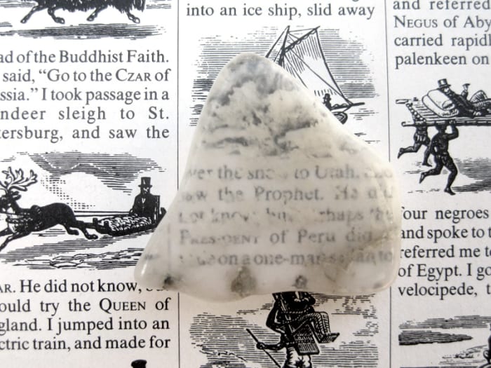 No, ulexite is not transparent, but milky white all the way through. The image you see is projected on top of the rock!