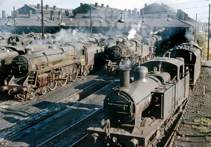 A BR Midland Region shed in the final days of steam - the nearest loco, an 0-6-0 'Jinty' tank loco has seen better days, with younger Ivatt 2-6-0 and BR Standard Class 5 4-6-0 to her right