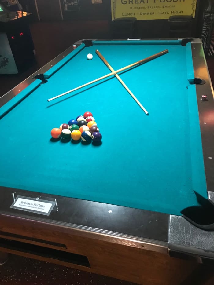 If you ever see a racked table with two cues crossed, it means the players will return shortly and are likely using the restroom, getting a drink, or taking a smoke break. Don't make the mistake of thinking it's a free table.