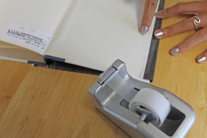 Put a little transparent tape to hold the cover in place so that you can put the washi or masking tape over it.
