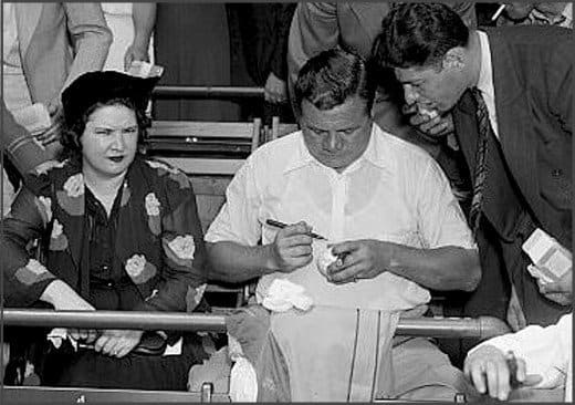 That's Babe Ruth's wife Claire next to him while he obligingly signs a fan's baseball. She sometimes signed his through-the-mail autograph requests and did a pretty good job of mimicking his signature.
