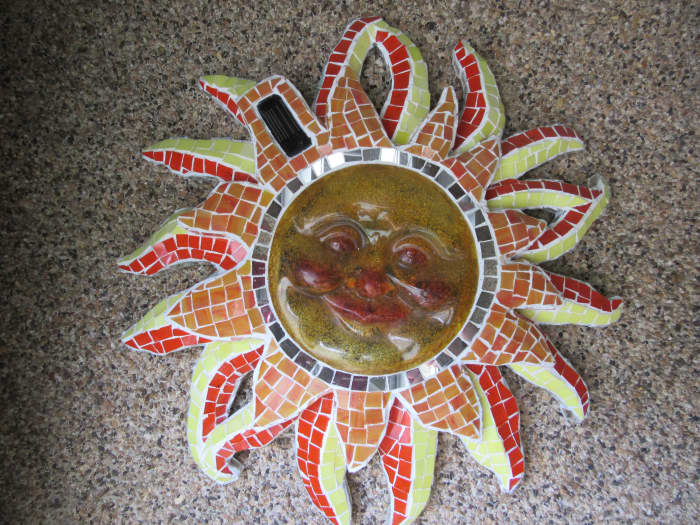 Using a glass mosaic technique on a common plastic piece adds richness to this solar light fixture.