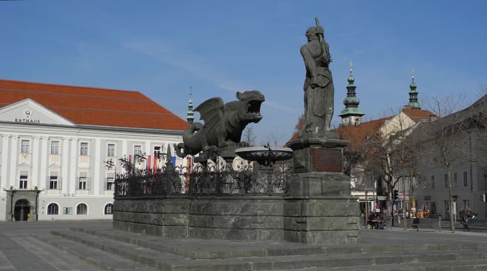 A postcard view taken well after hostilities were over, of the Neuer Platz (New Square) with the Rathaus (Town Hall) behind the dragon - see narrative below for an explanation of the myth associated with it and the club-wielding giant (nearside)