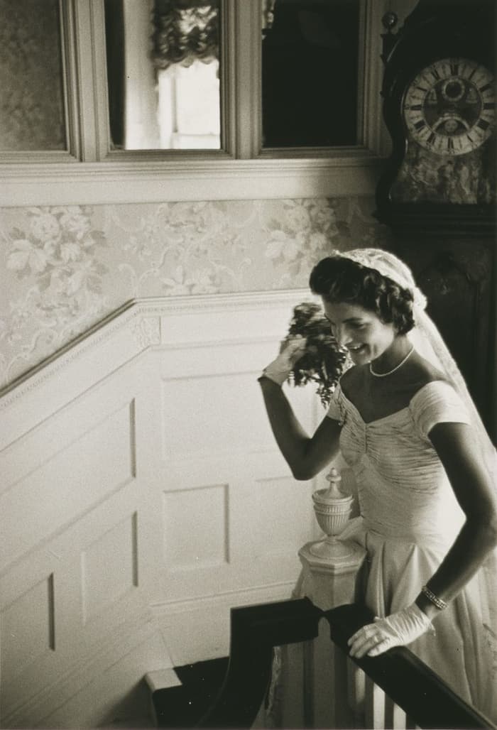 Jacqueline Kennedy at her 1953 wedding to John F. Kennedy. Jackie is throwing the bouquet. This photo was taken on September 12, 1953.