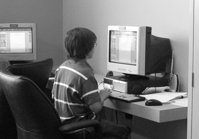 My ten-year-old writer working on his newspaper article on a homeschool field trip at Exchange City.