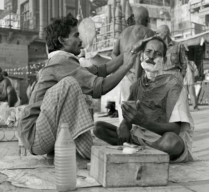 This is a man shaving another man. Teens in my day just shaved by ourselves--part of our growing up ritual in America.