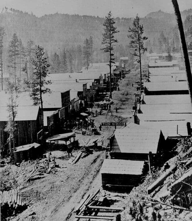 A photograph of Deadwood in 1876. General view of the Dakota Territory gold rush town from a hillside above.