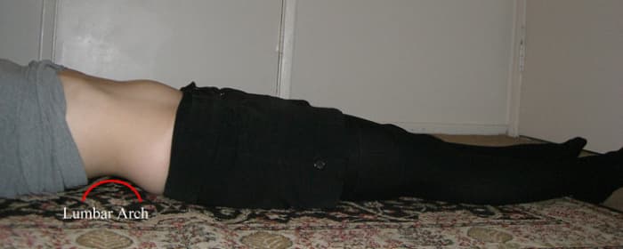 The curve of the spine while legs are extended. Take full deep breathes while relaxing to warm up. Just get your body to pay attention to the state of overall tension, take in more oxygen, and relax.