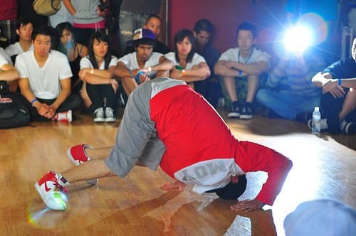 B-boys perform to an audience. Though dancers are incredibly athletic, not many people would consider dancing to be a sport.
