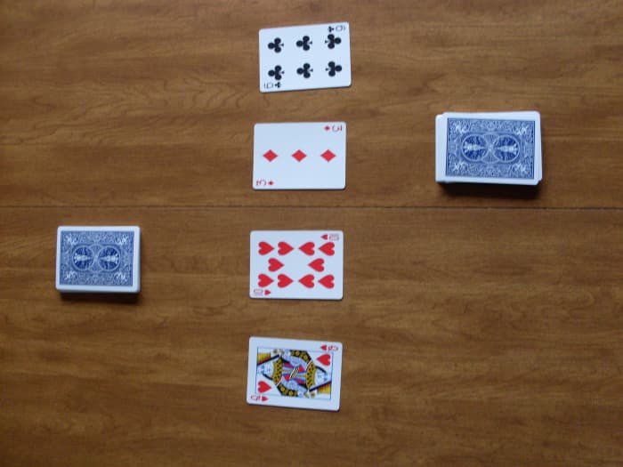 Here you see how the game should look before anyone has taken a turn. There are two draw piles with four cards in the center.