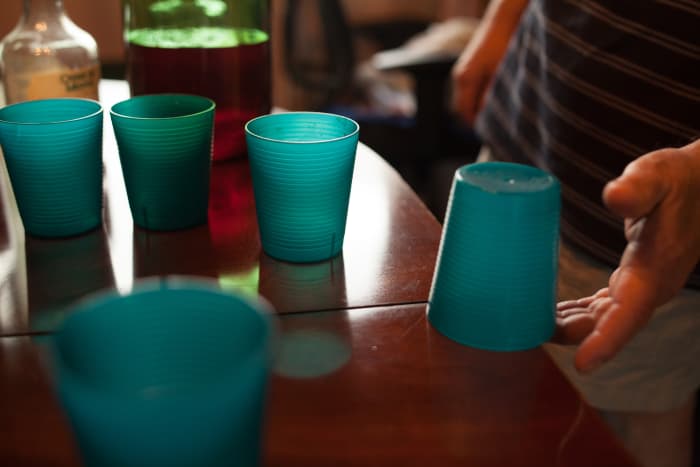 When finished with a beer players place cups upside down on the table and try to flick the cups by their overhanging rims to turn the cups right side up.