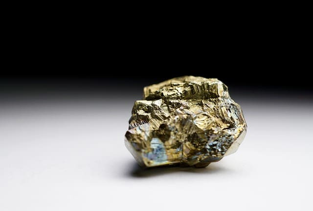 The pyrite has a more angular crystalline structure, and while gold colored, it is not as bright gold as the real thing