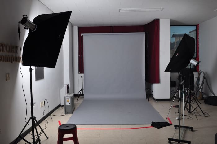 Use one wall for the dual function of practicing in front of a stage and for photographing or video taping promotional material.