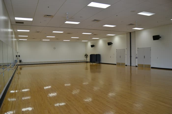 The first studio can be a simple empty room as floor space and mirrors are the two most essential tools for the instructor and students..