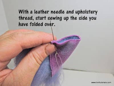 3. Using a leather needle and upholstery thread, sew up one side and back down again for added strength.