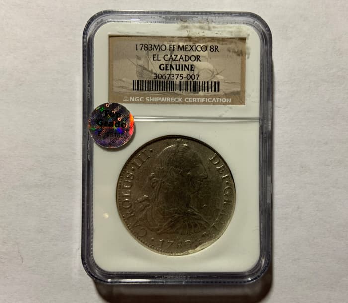 A professionally graded and authenticated coin. Not all holders say the word “Genuine”; it is implied by being in a professionally graded coin holder.