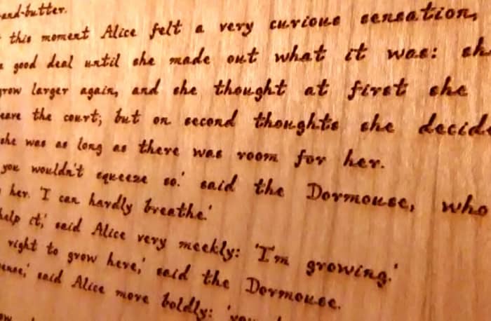 The engraved text on the wood pages was designed to resemble Lewis Carroll's handwriting.