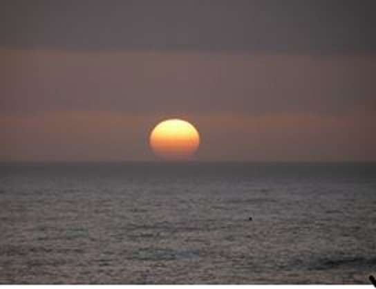 In this undated photo, the sun sets on the Pacific Ocean off California's Big Sur region.